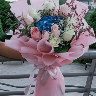 Mix of Roses and Blue Hydrangea wrapped with a pink layer